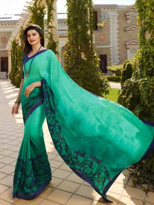 For Your Casual Or Semi-Casual Wear, Grab This Printed Saree In Sea Green Color Paired With Contrasting Navy Blue Colored Blouse. This Saree Is Fabricated On Georgette Paired With Art Silk Fabricated Blouse. 