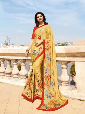 Celebrate This Festive Season Wearing This Printed Saree In Yellow Color Paired With contrasting Red Colored Blouse. This Saree Is Fabricated On Georgette Paired With Art Silk Fabricated Blouse. Both The Fabrics Are Light Weight And Easy To Carry All Day Long.