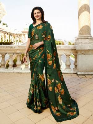 Shine Bright In This Beautiful Dark Green Colored Saree Paired With Dark Green Colored Blouse. This Saree Is Fabricated On Georgette Paired With Art Silk Fabricated Blouse. It Is Light In Weight And Easy To Carry All Day Long. 