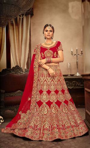 Get Ready For Your Big Day With This Heavy Designer Lehenga Choli In Red Color. This Heavy Embroidered Lehenga Choli Is Fabricated On Velvet Paired With Net Fabricated Dupatta. It Is Beautified With Heavy Jari & Thread Embroidery and Stone Work. Buy Now