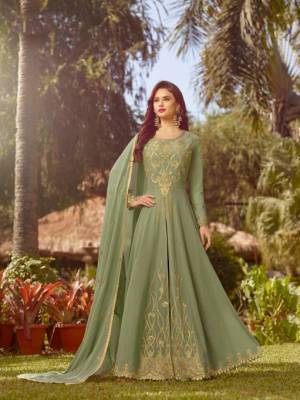 This Season Is About Subtle Shades And Pastel Play, So Grab This Heavy Designer Floor Length Suit In Pastel Green Color. Its Top And Dupatta Are Georgette Based Paired With Santoon Bottom. 