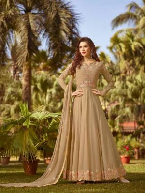 Flaunt Your Rich And Elegant Taste In This Designer Floor Length Suit In Beige Color. This Pretty Suit Is Georgette Based Beautified with Jari And Thread Work. Buy This Suit Now.