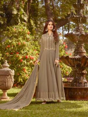 Add This New Shade To Your Wardrobe With This Designer Floor Length Suit In Sand Grey Color Paired With Sand Grey Colored Bottom And Dupatta.  This Designer Suit Is Georgette Based Beautified With Embroidery.
