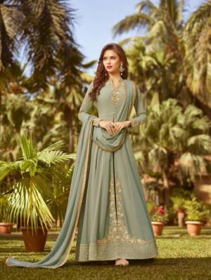 This Season Is About Subtle Shades And Pastel Play, So Grab This Heavy Designer Floor Length Suit In Mint Green Color. Its Top And Dupatta Are Georgette Based Paired With Santoon Bottom. 