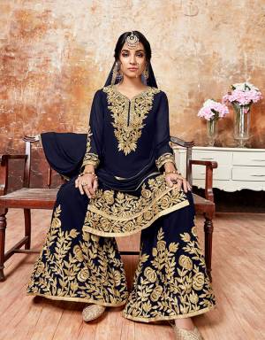 Here Is A Beautiful Designer Sharara Suit For The Upcoming Festive And wedding Season. Its Top And Bottom Are Georgette Based Paired With Chiffon Dupatta. It Is Beautified With Gota Ribbon Work All Over. 