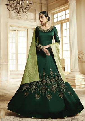 Here Is A Beautiful Heavy deisgner Floor Lengtj Suit In Dark Green Color Paired With Light Green Colored Dupatta. Its Top Is Fabricated On Satin Georgette Paired With Santoon Bottom And Banarasi Art Silk Dupatta. It Is Beautified With Elegant Embroidery Work. Buy This Semi-Stitched Suit Now.