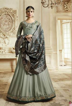 Flaunt Your Rich And Elegant Taste Wearing This Designer Floor Length Suit In Aqua Blue Color Paired With Contrasting Dark Teal Colored Dupatta. Its Top IS Georgette Based Paired With Santoon Bottom And Banarasi Art Silk Dupatta. Buy Now.