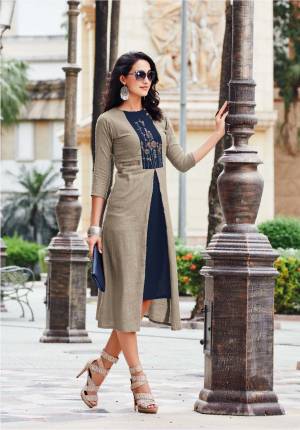 Enhance Your Personality Wearing This Designer Readymade Kurti In Grey And Navy Blue Color Fabricated On Linen. It Has Pretty Thread Work And Tassels over the Yoke. Buy Now.
