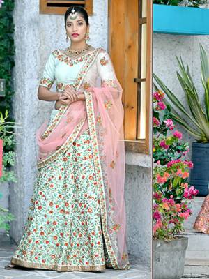 Here Is A Very Pretty And Subtle Color Pallete With This Heavy Designer Lehenga Choli In Pastel Green Color Paired With Contrasting Baby Pink Colored Dupatta. This Lehenga Choli Silk Based Paired With Net Fabricated Dupatta. It Is Beautufied With Contrasting Embroidery Giving It An Attractive Look. 
