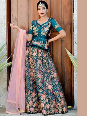 Get Ready For The Upcoming Wedding Season With This Heavy Designer Lehenga Choli In Blue Color Paired With Contrasting Baby Pink Colored Dupatta. This Lehenga Choli Is Fabricated On Satin Silk Paired With Net Fabricated Dupatta. 