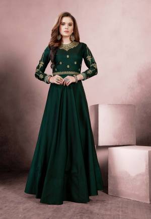 Celebrate This Festive Season Wearing This Designer Floor Length Readymade Gown In Dark Green Color Fabricated On Tafeta Silk. It Is Beautified With Heavy Embroidery Over The Yoke And Sleeves. 
