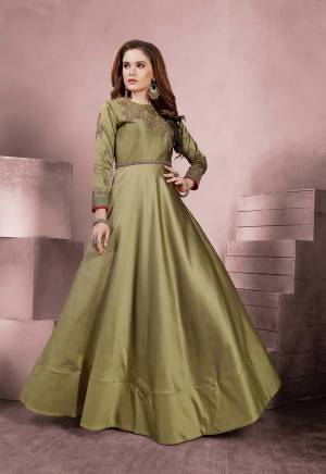 Add This Pretty Shade To Your Wardrobe With This Designer Floor Length Readymade Gown In Olive Green Color Fabricated On Tafeta Silk Beautified With Embroidery Over the Yoke And Sleeves. Buy Now.