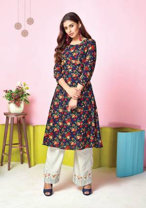 For Your Semi-Casual Wear, Grab This Pretty Set Of Kurti And Plazzo In Navy Blue Colored Kurti Paired With White Colored Plazzo. Its Top And Bottom Are Fabricated On Muslin Beautified With Prints And Thread Work. 