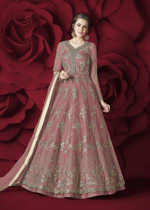 Flaunt Your Rich and Elegant Taste Wearing This Designer Floor Length Suit In Pink Colored Top Paired With Pink Colored Bottom And Dupatta. Its Top Is Fabricated On Net Paired With Silk Bottom And Net Dupatta. Its Rich and Elegant Embroidery Will Earn Your Lots Of Compliments From Onlookers.