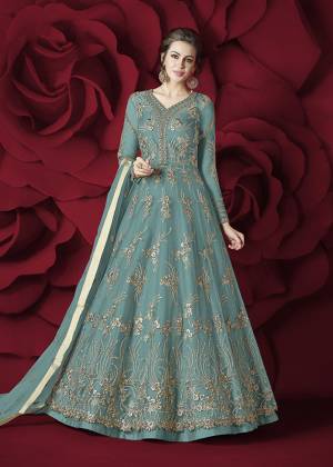 Flaunt Your Rich and Elegant Taste Wearing This Designer Floor Length Suit In Turquoise Blue Colored Top Paired With Turquoise Blue Colored Bottom And Dupatta. Its Top Is Fabricated On Net Paired With Silk Bottom And Net Dupatta. Its Rich and Elegant Embroidery Will Earn Your Lots Of Compliments From Onlookers.