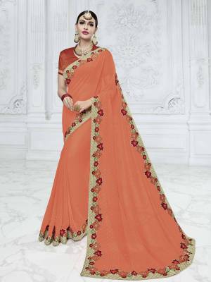 Vibrant and visually appealing, this orange color georgette saree. Ideal for party, festive & social gatherings. this gorgeous saree featuring a beautiful mix of designs. Its attractive color and designer heavy embroidered design, Flower embroidered patch design, stone design, beautiful floral design work over the attire & contrast hemline adds to the look. Comes along with a contrast unstitched blouse.