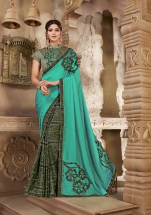 New And Unique Color Pallete Is Here With This Designer Saree In Sea Green And Grey Color Paired With Grey Colored Blouse. This Saree And Blouse Are Silk Based Beautified With Prints And Patch Work. 