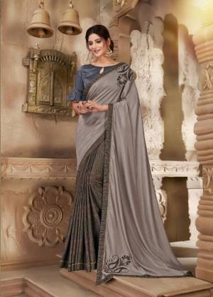 Flaunt Your Rich And Elegant Taste Wearing This Designer Saree In Grey Color Paired With Dark Grey Colored Blouse. It Is Rich Silk Based Which Gives A Rich And Elegant Look To Your Personality. 