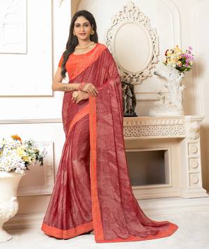 Adorn The Pretty Angelic Look In This Red Colored Saree Paired With Contrasting Orange Colored Blouse. This Saree Is Fabricated On Georgette Chiffon Paired With Art Silk Fabricated Blouse. It Is Beautified With Prints And Stone Work. 