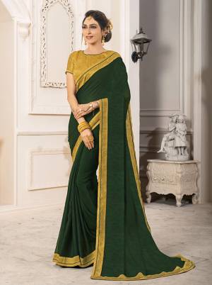 Here Is A Beautiful Designer Dark Green Colored Saree Paired With Contrasting Pear Green Colored Blouse. This Saree Is Fabricated On Georgette Chiffon Paired With Art Silk Fabricated Blouse. It Is Light In Weight And Easy To Carry All Day Long. Buy Now.