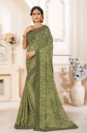New Shade Is Here To Add Into Your Wardrobe With This Designer Saree In Olive Green Color Paired With Olive Green Colored Blouse. This Saree Is Fabricated On Georgette Chiffon Paired With Art Silk Fabricated Blouse. Its Rich Color And Fabric Will Earn You Lots Of Compliments From Onlookers. 
