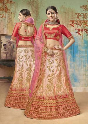 Shine Bright Wearing This Heavy Designer Lehenga Choli In Red Colored Blouse Paired With Light Peach Lehenga And Pink Colored Dupatta. Its Blouse And Lehenga Are Satin Silk Based Paired With Net Fabricated Dupatta. It Is Beautified With Heavy Embroidery All Over. 