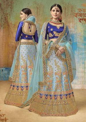 Bright And Visually Appealing Color Is Here With This Heavy Designer Lehenga Choli In Royal Blue Colored Blouse Paired With Light Blue Colored Lehenga And Dupatta. Its Blouse And Lehenga Are Fabricated On Satin Silk Paired With Net Fabricated Dupatta. 