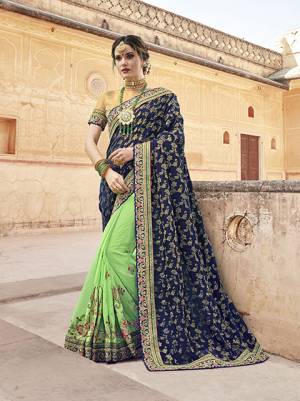 Grab This Beautiful Designer Saree In Navy Blue And Light Green Color Paired With Beige Colored Blouse. This Saree Is Fabricated On Jacquard Silk And Georgette Paired With Art Silk Fabricated Blouse. Both Its Fabric Ensures Superb Comfort All Day Long. 