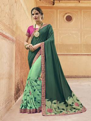 Go With The Shades Of Green With This Designer Saree In Teal Green And Sea Green color Paired With Contrasting Rani Pink Colored Blouse. This Saree Is Georgette based Paired With Art Silk Fabricated Blouse. It Has Pretty Unique Color Pallete Which Earns You Lots Of Compliments From Onlookers. 