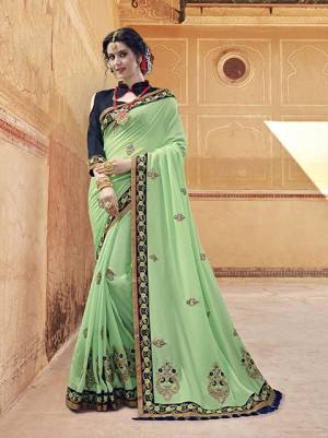 This Season Is About Subtle Shades And Pastel Play So Grab This Designer Saree In Pastel Green Color Paired With Contrasting Navy Blue Colored Blouse. This Saree Is Fabricated On Silk Georgette Paired With Art Silk Fabricated Blouse. Buy Now.