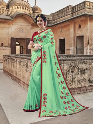 Here Is A Heavy Designer Saree In Sea Green Color Paired With Red Colored blouse. This Saree Is Fabricated On Silk Georgette Paired With Silk Based Blouse, Beautified With Heavy Embroidery With Contrasting Thread Work Making It More Attractive. 