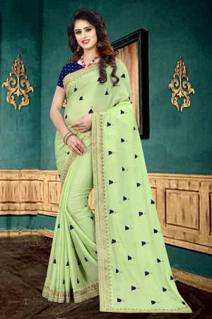 Very Pretty Shade In Here With This Designer Saree In Light Green Color Paired With Navy Blue Colored Blouse. This Saree Is Fabricated On Georgette Paired With Brocade Fabricated Blouse. It Has Pretty Butti Work All Over It With Embroidered Lace Border. 