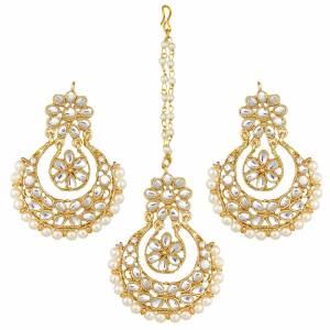 Give Unique And Attractive Look To Your Traditional Attire By Pairing It With This Beautiful Set Of Maang Tika And Earrings. This Pretty Set Can Be Paired With Any Colored Traditional Attire. Buy Now.