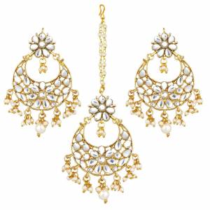 Give Unique And Attractive Look To Your Traditional Attire By Pairing It With This Beautiful Set Of Maang Tika And Earrings. This Pretty Set Can Be Paired With Any Colored Traditional Attire. Buy Now.