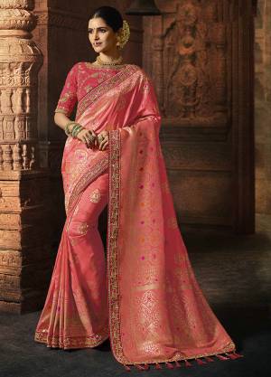 Look Pretty Wearing This Designer Saree In Pink Color Paired With Dark Pink Colored Blouse. This Rich Silk Based Saree Is Beautified With Detailed Weave And Heavy Embroidery.