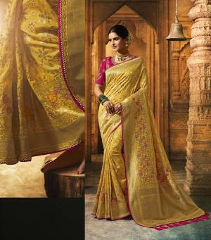 Celebrate This Festive And Wedding Season With A Proper Traditional Look In Silk Based Saree In Yellow Paired With Contrasting Dark Pink Colored Blouse. It IS Beautified With Weave And Heavy Embroidery. Buy This Lovely Saree Now.