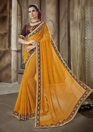 Celebrate This Festive Season Wearing This Musturd Yellow Colored Saree Paired With Contrasting Brown Colored Blouse. This Saree Is Georgette Based Paired With Art Silk Fabricated Blouse. 
