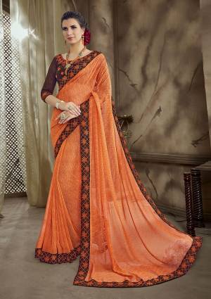 Look Beautiful Wearing This Bright Orange Colored Saree Paired With Contrasting Brown Colored Blouse. This Saree IS Georgette Based Paired With Art Silk Fabricated Blouse. 