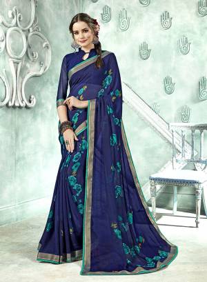 Simple Saree Is Here For Your Casual Wear In Navy Blue Color Paired With Navy Blue Colored Blouse. This Saree And Blouse Are Fabricated On Georgette Beautified With Prints And lace Border. 