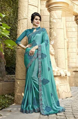 Here Is A Very Pretty And Subtle Shade Designer Saree In Turquoise Blue Color Paired With Turquoise Blue Colored Blouse. This Saree Is Fabricated On Satin Paired With Art Silk Fabricated Blouse. It Is Beautified With Tone To Tone Embroidery Making It More Attractive. 