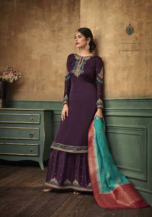 New And Unique Color Pallete Is Here With This Beautiful Designer Sharara Suit In Wine Color Paired With Contrasting Turquoise Blue Colored Dupatta. Its Top And Bottom Are Satin Georgette Based Paired With Banarasi Silk Dupatta. Its Pretty Color And Fabric Will Earn You Lots Of Compliments From Onlookers.
