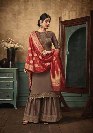 Enhance Your Personality In This Rich Combination Of Designer Sharara Suit In Brown Color Paired With Contrasting Red Colored Dupatta. Its Top And Bottom Are Satin Georgette Fabricated Paired With Banarasi Silk Dupatta. Buy This Semi-Stitched Suit Now.