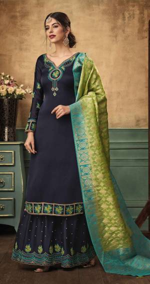 New And Unique Color Pallete Is Here With This Beautiful Designer Sharara Suit In Navy Blue Color Paired With Contrasting Parrot Green Colored Dupatta. Its Top And Bottom Are Satin Georgette Based Paired With Banarasi Silk Dupatta. Its Pretty Color And Fabric Will Earn You Lots Of Compliments From Onlookers.