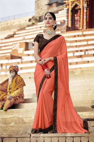 Celebrate This Festive Season Wearing This Designer Saree In Peach Color Paired With Brown Colored Blouse. This Saree Is Georgette Based Paired With Art Silk Fabricated Embroidered Blouse. Buy Now.