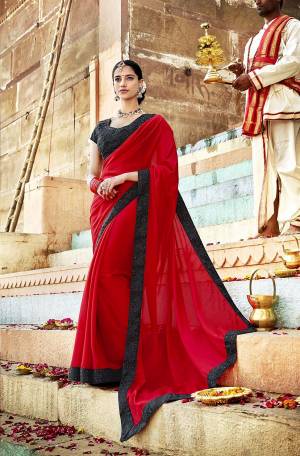 Adorn The Pretty Angelic Look Wearing This Designer Saree In Red Color Paired With Black Colored Blouse. This Saree Is Georgette Based Paired With Art Silk Fabricated Blouse. It Is Beautified With Embroidery Over The Blouse And Saree Lace Border.