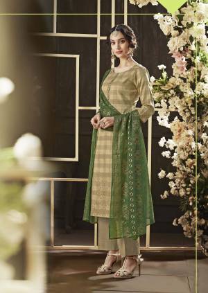 Rich And Elegant Looking Designer Straight Suit Is Here In Beige Color Paired With Contrasting Green Colored Dupatta. Its Top And Bottom Are Cotton Based Paired With Chiffon Dupatta. It Is Beautified With Foil Print Over Top And Dupatta. 