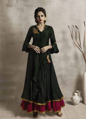 Here Is A Very Pretty Designer Readymade Double Layered Gown In Dark Green And Rani Pink Color. This Kurti Is Fabricated On Satin Linen Which Gives A Rich Look To Your Personality. 