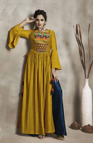 Celebrate This Festive And Wedding Season Wearing This Designer Kurti In Musturd Yellow color Paired With Contrasting Navy Blue Colored Bottom. Its Top And Bottom Are Satin Linen Fabricated Beautified With Heavy Embroidered Multi Colored Yoke. Buy Now.