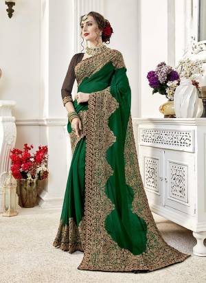 Celebrate This Festive Season Wearing This Pretty Dark Green Colored Saree Paired With Brown Colored Blouse. This Saree Is Georgette Based Paired With Art Silk Fabricated Blouse. Buy Now.