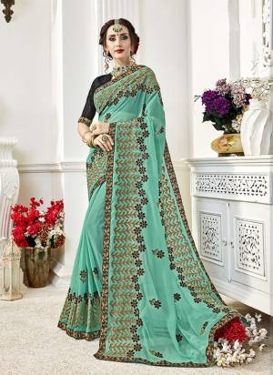 Look Beautiful Wering This Designer Saree In Aqua Blue Color Paired With Black Colored Blouse. This Saree Is Fabricated On Georgette Paired With Art Silk Fabricated Blouse. Its Pretty Color And Embroidery Is Giving An Attractive Look. 